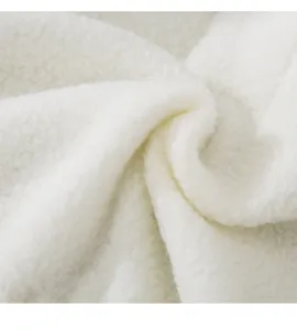 White sherpa fabric close-up detail showcasing soft fluffy fleece texture for pet clothing items