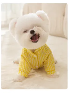 Detailed view of cute pet winter cotton coat in yellow grid design, cozy warm apparel for dogs.
