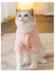 Detailed shot of a cute pink fleece pet coat, soft and warm winter wear for cats and small dogs.