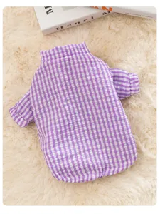 Detail view of purple plaid pet winter coat, soft warm thickened fabric with cute grid pattern.