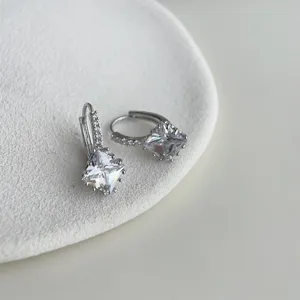 Closeup view of elegant square cubic zirconia huggie earrings with detailed micro pave sparkle.