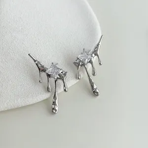 Detailed close-up of liquid metal earrings with sparkling micro-inlaid cubic zirconia.
