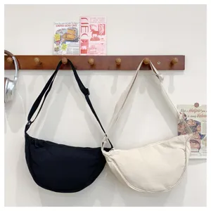 Close-up detail of the Japanese style canvas crescent shoulder bag, stylish minimalist design.