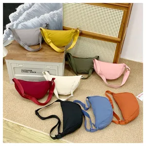 Detailed view of colorful casual canvas crescent shoulder bags arranged together nicely.