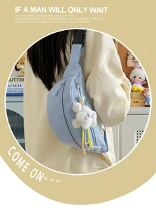 Close-up view of the light blue chest bag with wide strap and cute plush cloud pendant.