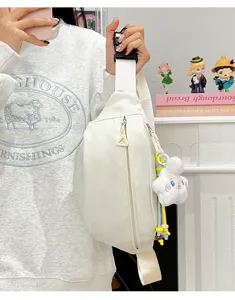 Close-up detail of white nylon fanny pack, wide strap and casual chest crossbody bag style.