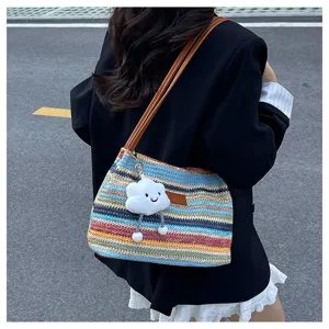 Colorful rainbow woven shoulder bag for women, stylish summer beach tote with cute cloud pendant.