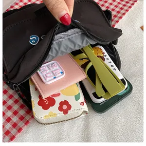 Solid color nylon small crossbody bag capacity detail view, casual student messenger bag.