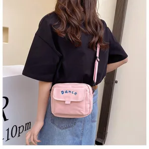 Pink nylon crossbody bag for women, cute Japanese style casual shoulder bag with front pocket.