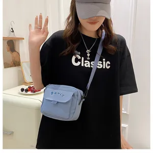 Detailed view of casual nylon crossbody bag featuring flap design and adjustable strap for daily use.