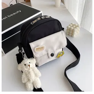 Canvas crossbody bag for women, cute small shoulder bag with bear pendant, black and white.