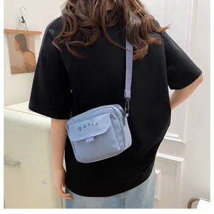 Solid color nylon crossbody bag, casual student shoulder bag with cute letter embroidery style.