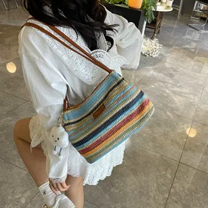 Colorful striped woven shoulder bag for women, stylish summer beach straw bucket handbag.