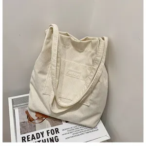 Corduroy tote bag detail view, minimal casual shoulder handbag for daily student use.