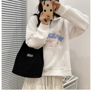 Casual corduroy shoulder bag and stylish waffle sweatshirt outfit for daily wear.
