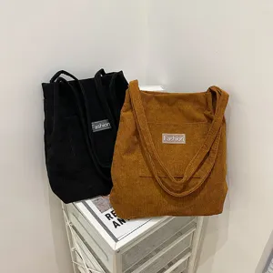 Casual corduroy tote bag with letter label, retro single shoulder handbag for students.