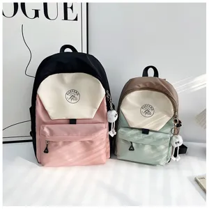 Detailed view of stylish Japanese color-block school backpacks with cute pendant and pocket.