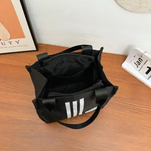 Bolso tote de lona negra con diseño de rayas, bolso de mano casual de moda para mujeres.