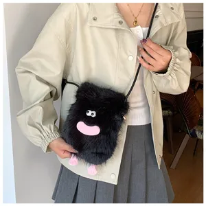 Detail shot of the cute fuzzy plush crossbody phone bag with funny monster design for women.