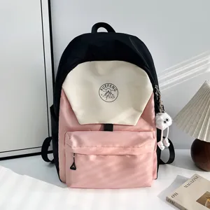 Detailed view of the stylish Japanese color-block student backpack with front pocket and plush charm.