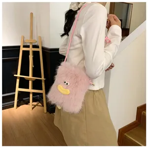 Fluffy pink crossbody phone bag with cute funny face design, soft plush mini shoulder bag style.