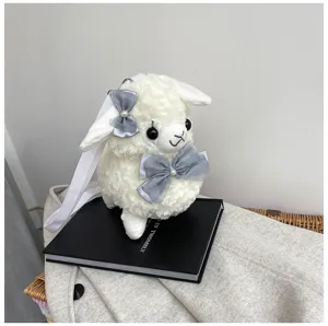 Close up of cute plush alpaca bag with soft white fleece and elegant grey bow details.