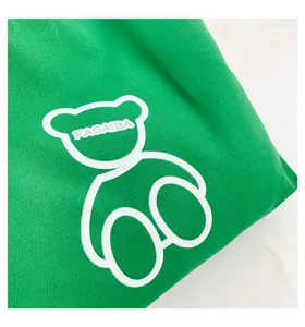 Green canvas bag with cute bear print and white letter detail, casual daily style.
