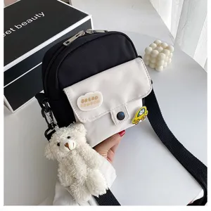 Canvas crossbody bag for women, cute black and white shoulder bag with bear plush and patches.