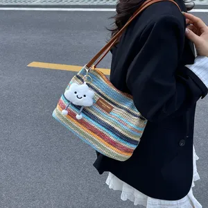 Colorful striped woven shoulder bag with cute cloud keychain, ideal for summer casual everyday wear.