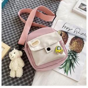 Cute pink canvas crossbody bag detail, sweet style student shoulder bag with bear pendant.