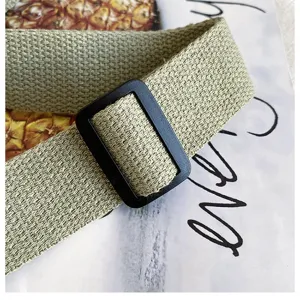 Crossbody bag canvas strap and buckle detail shot, showing durable texture and adjustable design.