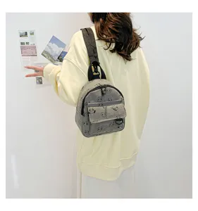 Close-up view of a cute mini canvas backpack with panda pattern in daily lifestyle scene display.