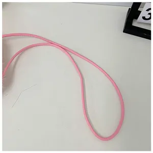 Pink plush mini bag shoulder strap detail showing soft texture and clean design.