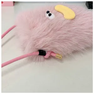 Pink plush phone bag detail showing fluffy texture, funny eyes and yellow lip design.