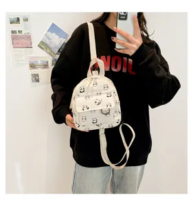 Detail view of the cute mini corduroy panda print backpack, showing front pocket and strap.