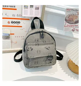 Detailed view of the cute grey corduroy mini backpack featuring adorable panda print and pockets.