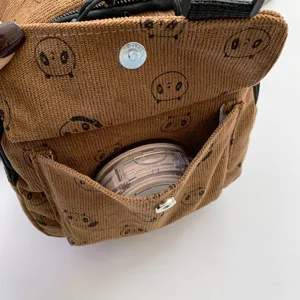 Brown corduroy mini crossbody bag with cute bear print, front pocket and magnetic snap closure.
