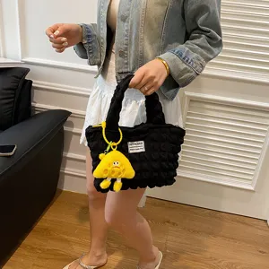 Stylish bubble pleated handbag for women with cute yellow plush charm, trendy casual tote bag.