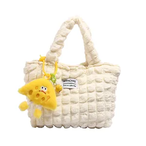 White puckered bubble handbag with cute yellow plush charm, stylish casual tote bag for women.