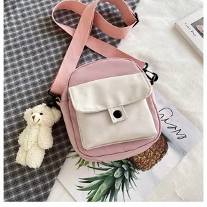 Canvas crossbody bag for women, sweet pink shoulder bag with cute teddy bear pendant.