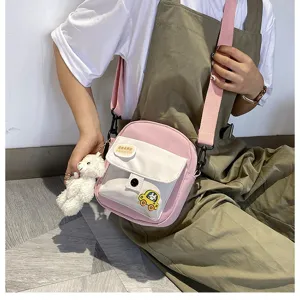 Cute pink canvas crossbody shoulder bag detail, sweet style phone bag with bear pendant.