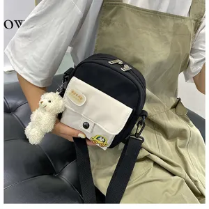Korean ins Harajuku style cute canvas crossbody shoulder bag for teen girls with small bear pendant.