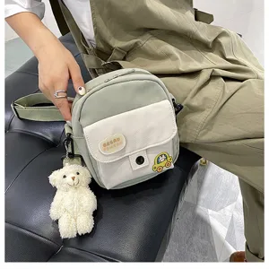 Cute canvas crossbody bag with fluffy bear charm, sweet student phone bag detail.