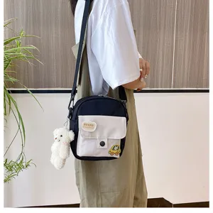 Detailed view of the cute canvas crossbody bag with fluffy bear pendant for daily casual wear.