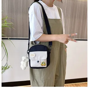 Canvas crossbody bag for women, cute small shoulder phone bag with bear pendant and patch.