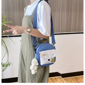 Casual Japanese Harajuku canvas crossbody bag with cute bear pendant and front pocket design.