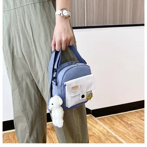 Cute Japanese style crossbody bag detail featuring plush sheep pendant and front pocket design.