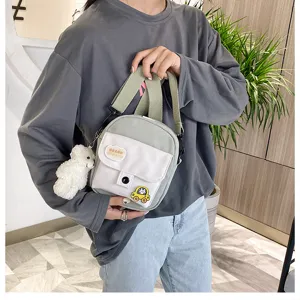 Canvas crossbody shoulder bag with cute bear pendant and cartoon patches for daily.