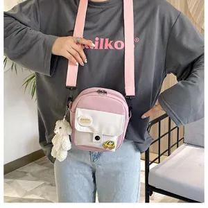 Cute Japanese style pink crossbody bag with white pocket and plush bear pendant for daily.