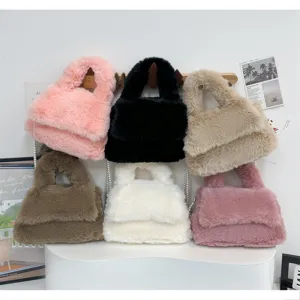 Fluffy faux fur handbag women Korean style versatile winter shoulder bag with pearl chain.
